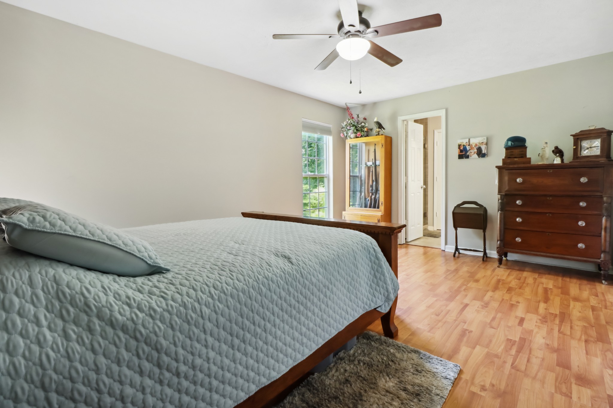 4956 Minnis Road Springfield, TN 37172 - Photo 26 of 32 a bedroom with a bed and a chandelier