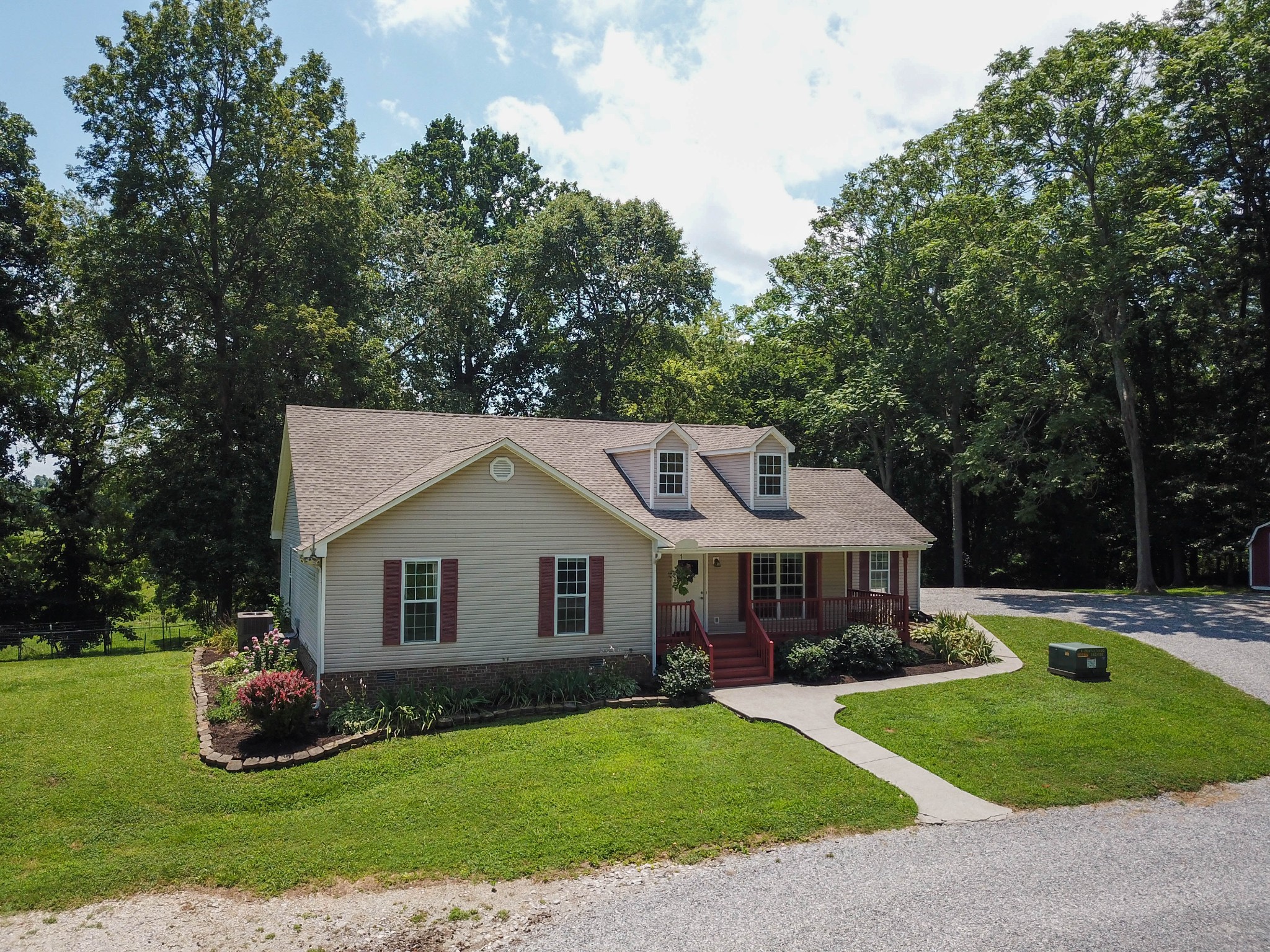 4956 Minnis Road Springfield, TN 37172 - Photo 3 of 32 a front view of a house with a garden and trees