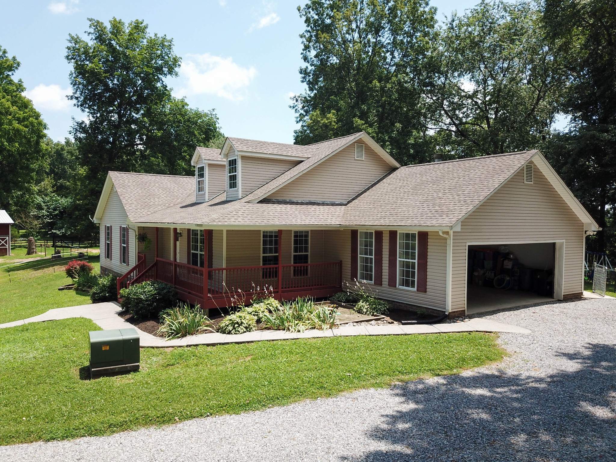 4956 Minnis Road Springfield, TN 37172 - Photo 4 of 32 a front view of a house with a garden and porch