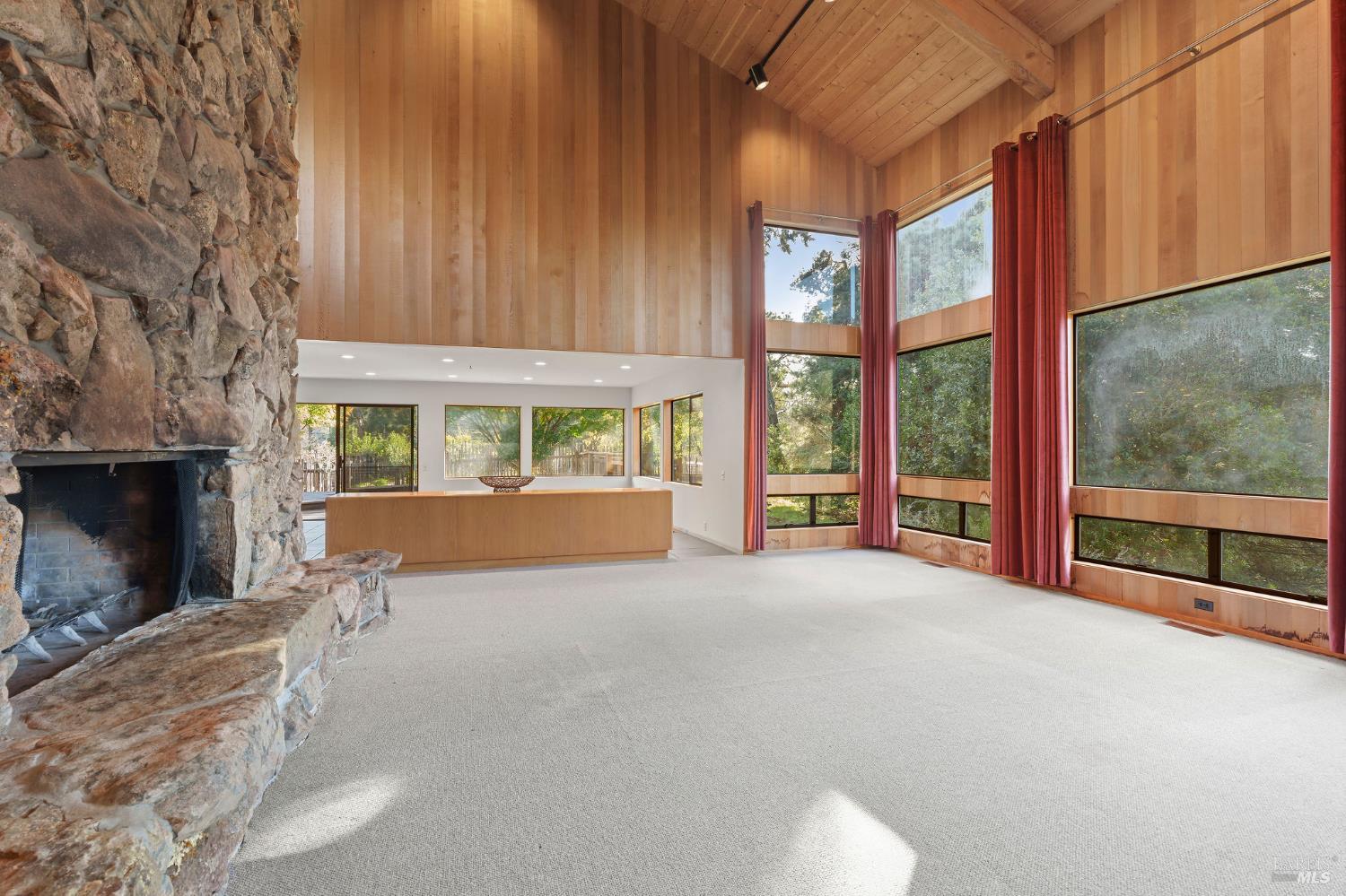 36029 Timber Ridge Road The Sea Ranch, CA 95497 - Photo 15 of 59 a view of an empty room with a fireplace and a window
