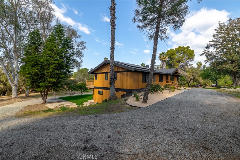 7744 West Lilac Road Bonsall, CA 92003 - Photo 11 of 60 a view of a house with backyard and tree