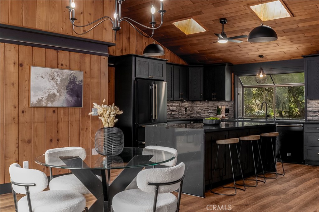 7744 West Lilac Road Bonsall, CA 92003 - Photo 16 of 60 a kitchen with a dining table and chairs