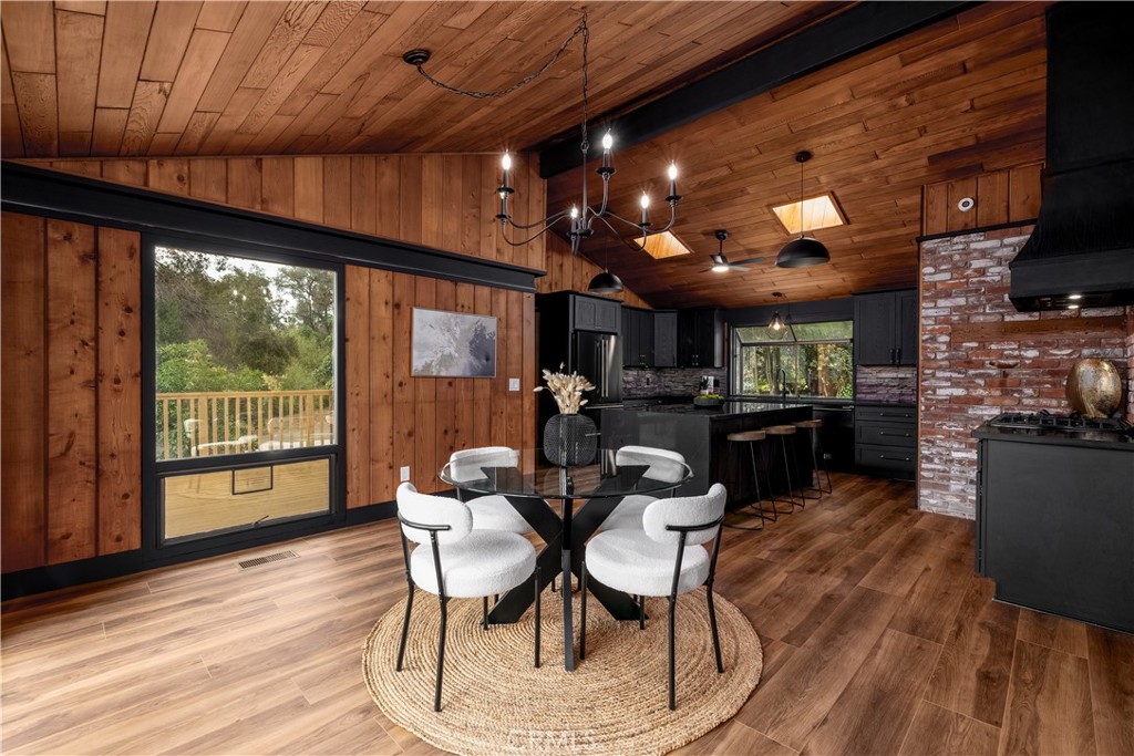 7744 West Lilac Road Bonsall, CA 92003 - Photo 17 of 60 a dining room with furniture and wooden floor
