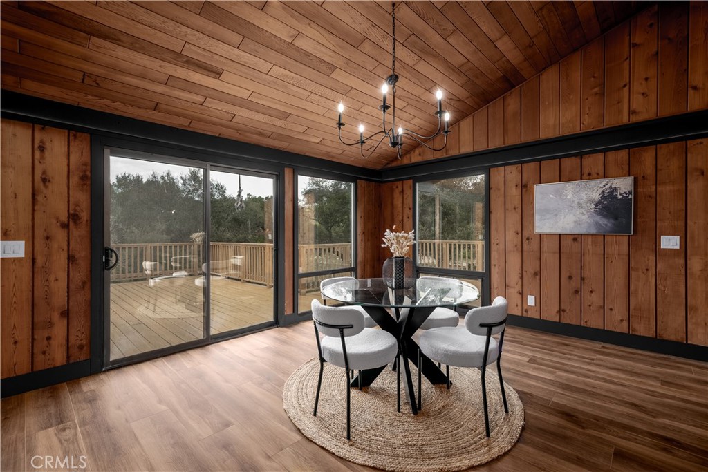 7744 West Lilac Road Bonsall, CA 92003 - Photo 18 of 60 a dining room with wooden floor glass table and chairs