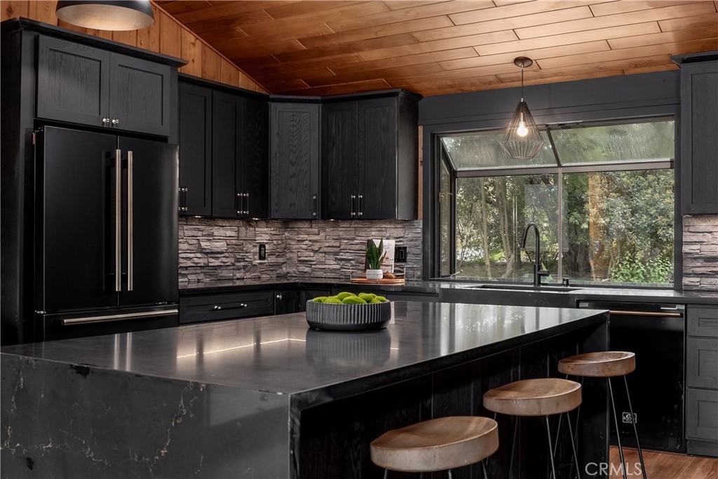 7744 West Lilac Road Bonsall, CA 92003 - Photo 19 of 60 a kitchen with stainless steel appliances granite countertop a sink a stove and a refrigerator