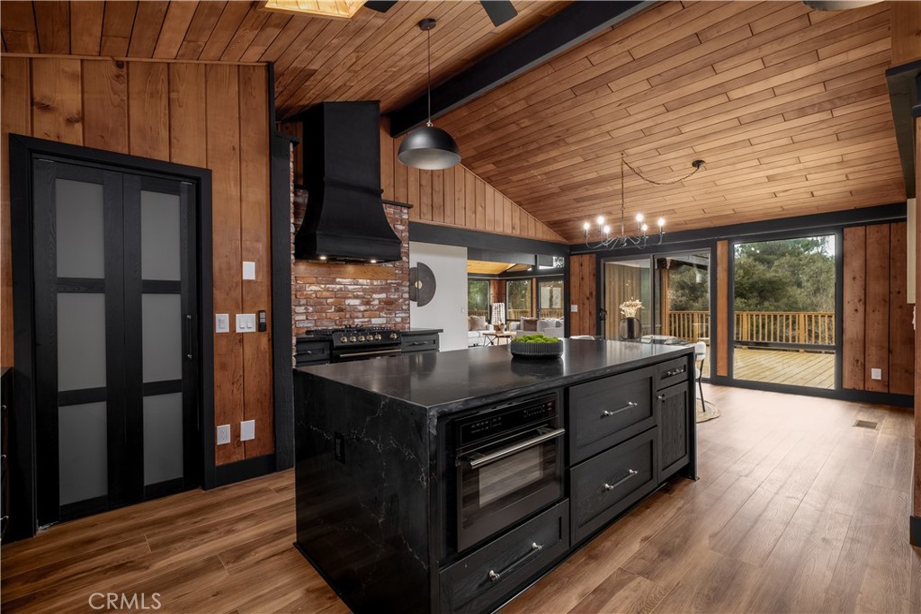 7744 West Lilac Road Bonsall, CA 92003 - Photo 21 of 60 a kitchen with stainless steel appliances granite countertop a stove and a wooden floors