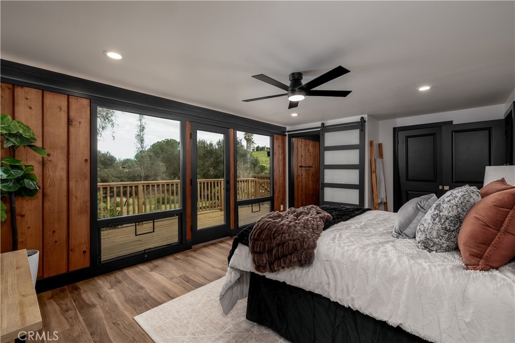 7744 West Lilac Road Bonsall, CA 92003 - Photo 32 of 60 a bedroom with a large bed and a large window