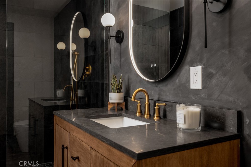 7744 West Lilac Road Bonsall, CA 92003 - Photo 34 of 60 a kitchen with a sink a mirror and vanity