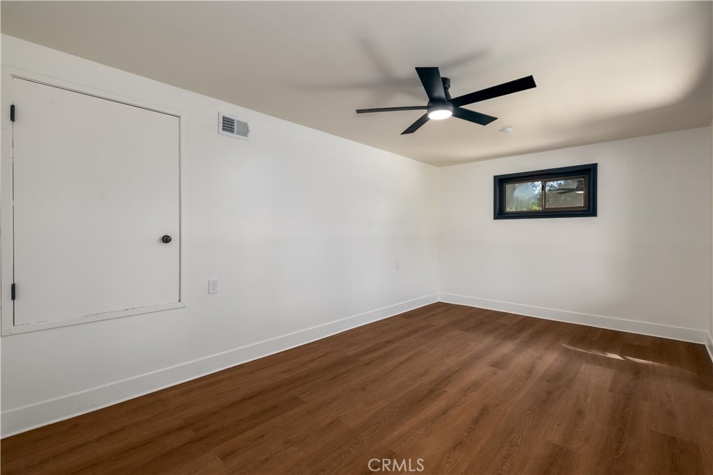 7744 West Lilac Road Bonsall, CA 92003 - Photo 37 of 60 a view of an empty room with wooden floor