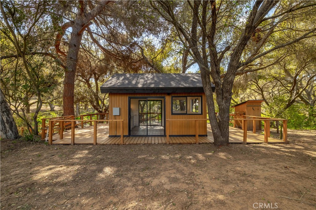 7744 West Lilac Road Bonsall, CA 92003 - Photo 42 of 60 a view of a house with a large tree and a big yard