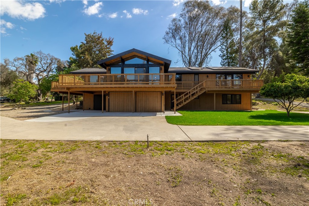 7744 West Lilac Road Bonsall, CA 92003 - Photo 47 of 60 a front view of a house with a yard and garage