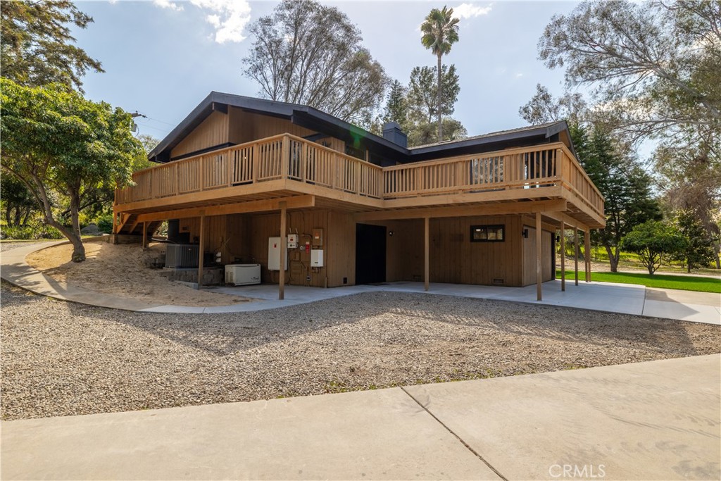 7744 West Lilac Road Bonsall, CA 92003 - Photo 48 of 60 a view of a house with a yard and large tree