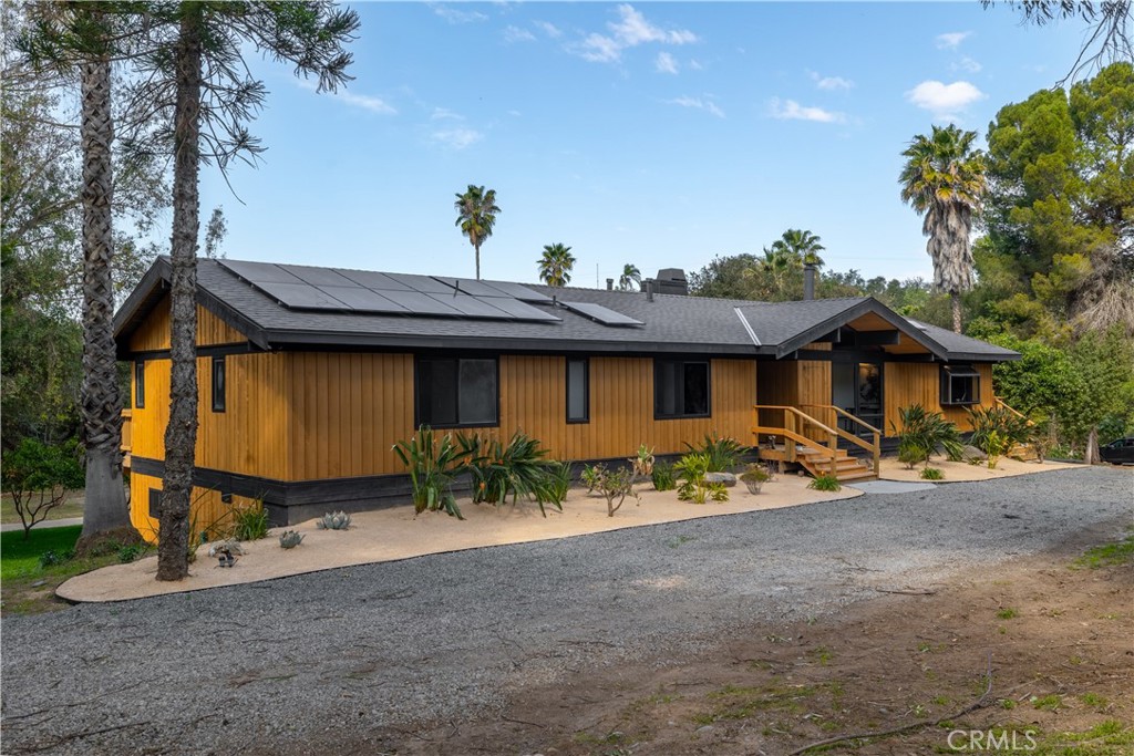 7744 West Lilac Road Bonsall, CA 92003 - Photo 8 of 60 a view of a house with a yard and sitting area