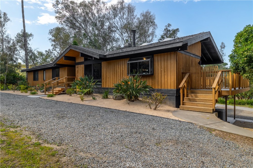 7744 West Lilac Road Bonsall, CA 92003 - Photo 9 of 60 a view of a house with a yard