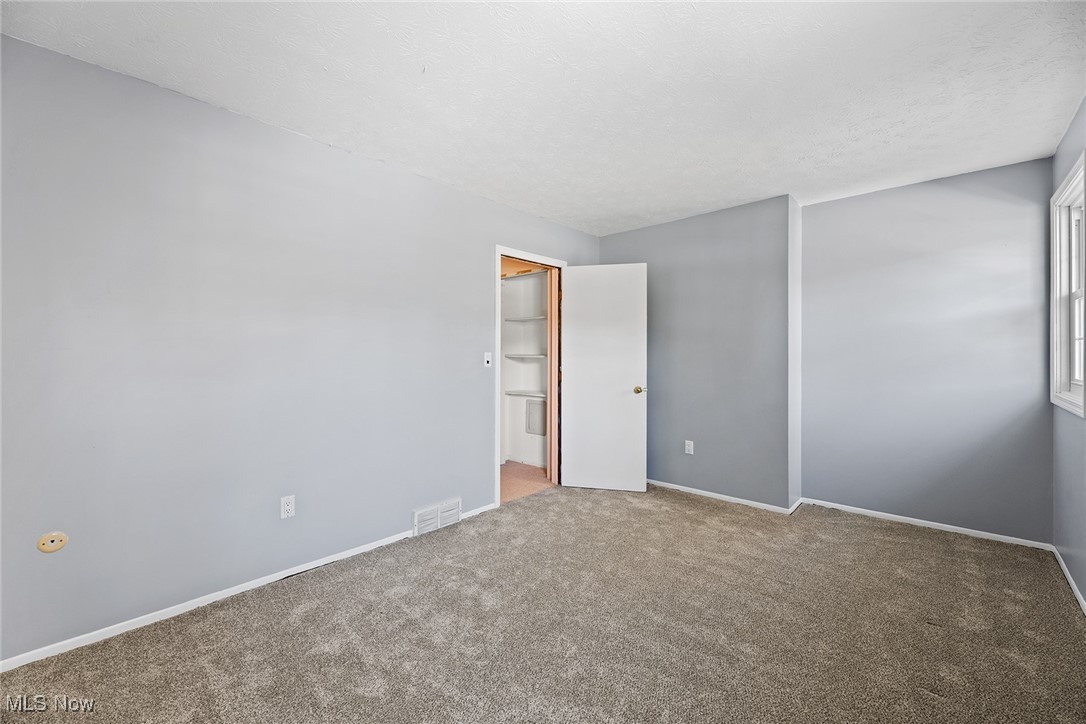 3550 Boston Road Brunswick, OH 44212 - Photo 24 of 37 Carpeted spare room with baseboards and a textured ceiling