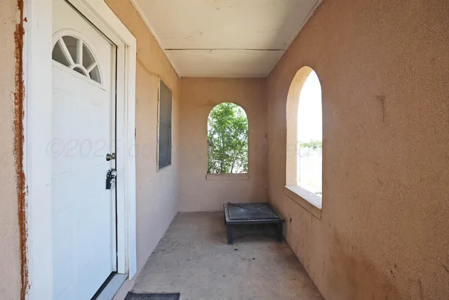 a view of a hallway with windows
