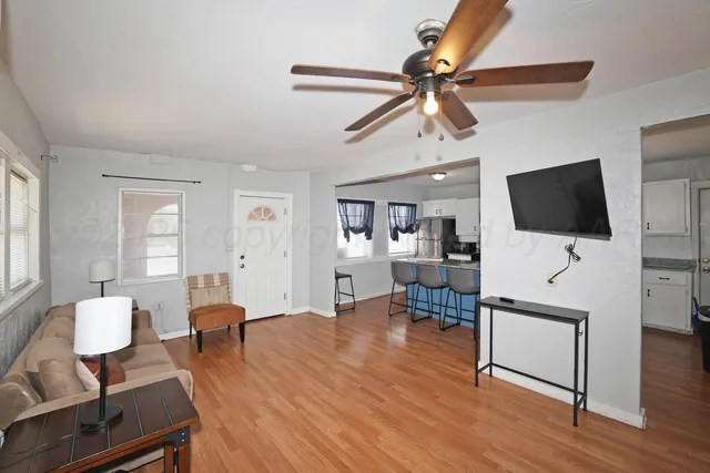 a living room with furniture and a flat screen tv
