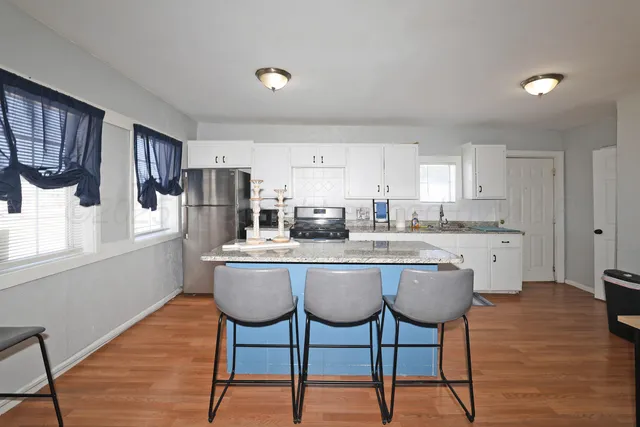 a view of a room with furniture and wooden floor