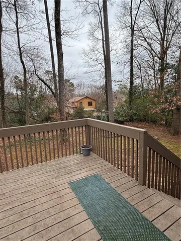 a view of balcony with wooden floor and fence