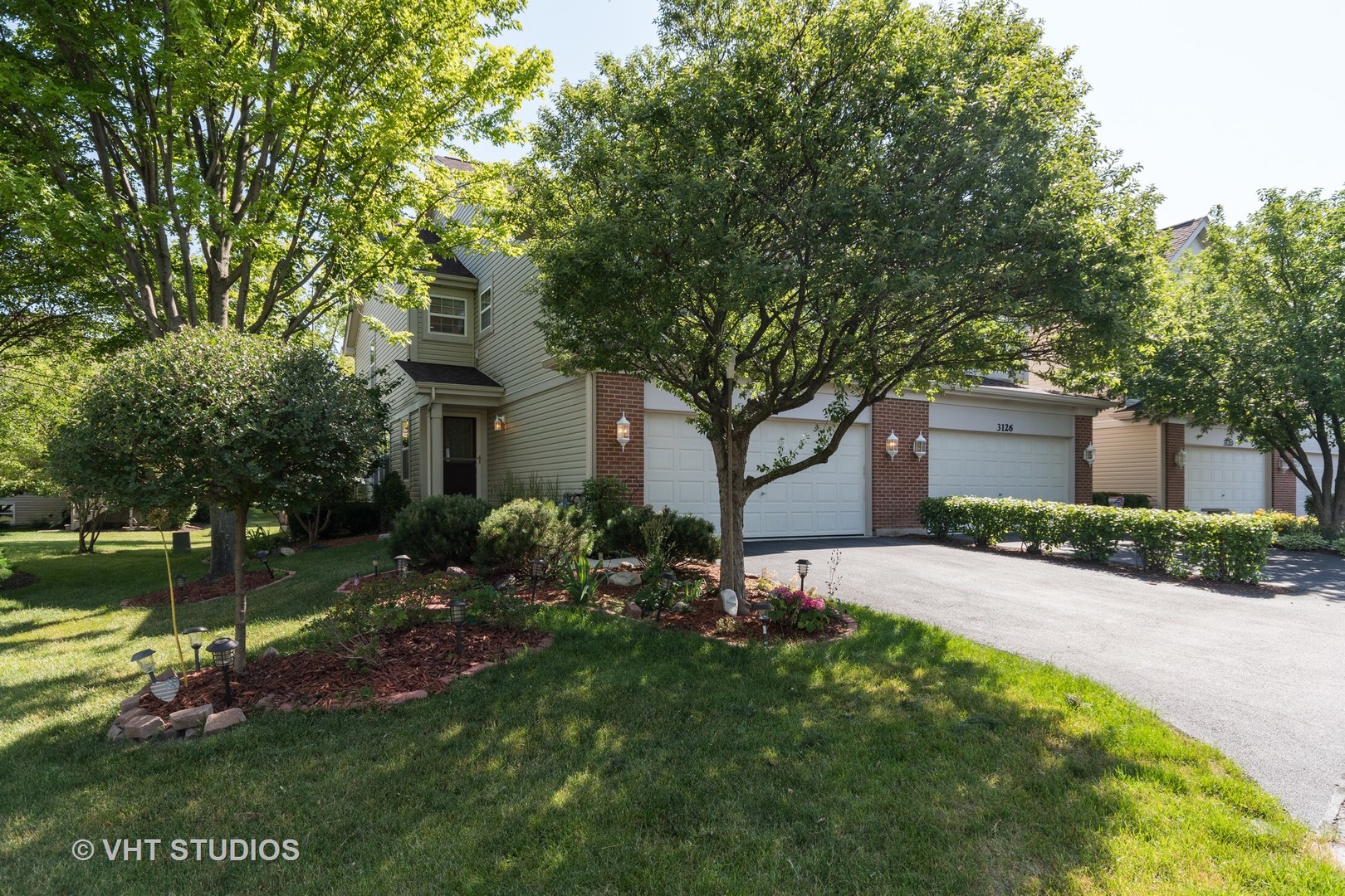 3132 Raphael Court St. Charles, IL 60175 - Photo 1 of 14 a front view of a house with a garden and plants