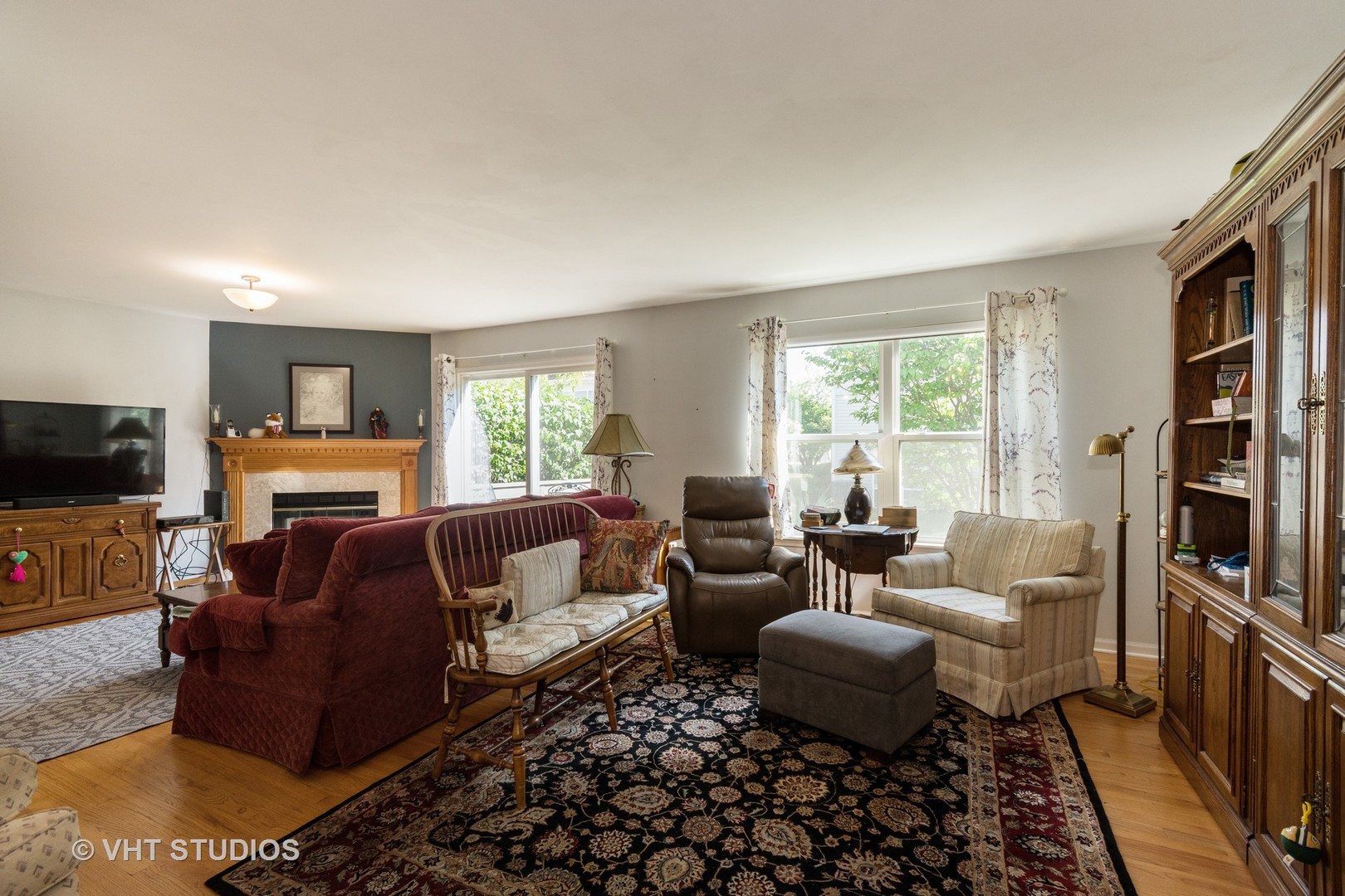 3132 Raphael Court St. Charles, IL 60175 - Photo 2 of 14 a living room with furniture fireplace and a flat screen tv