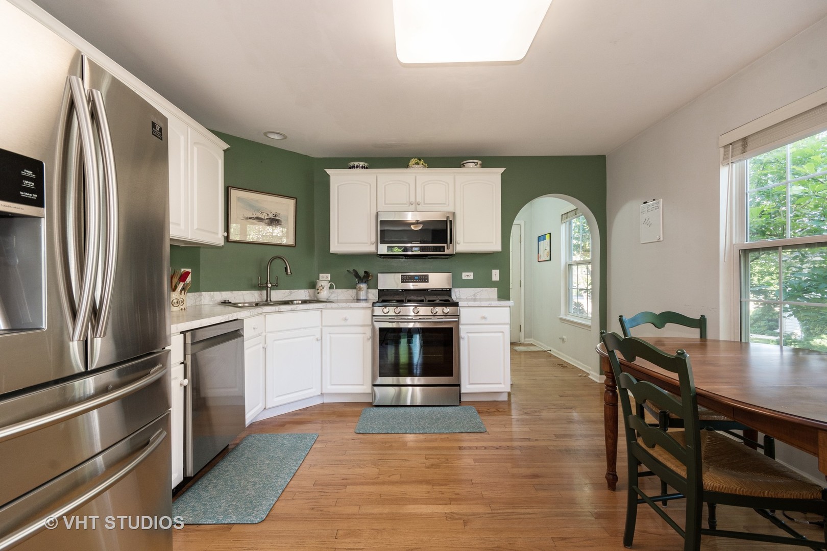 3132 Raphael Court St. Charles, IL 60175 - Photo 3 of 14 a kitchen with granite countertop a stove a sink dishwasher a refrigerator and a microwave oven with cabinets