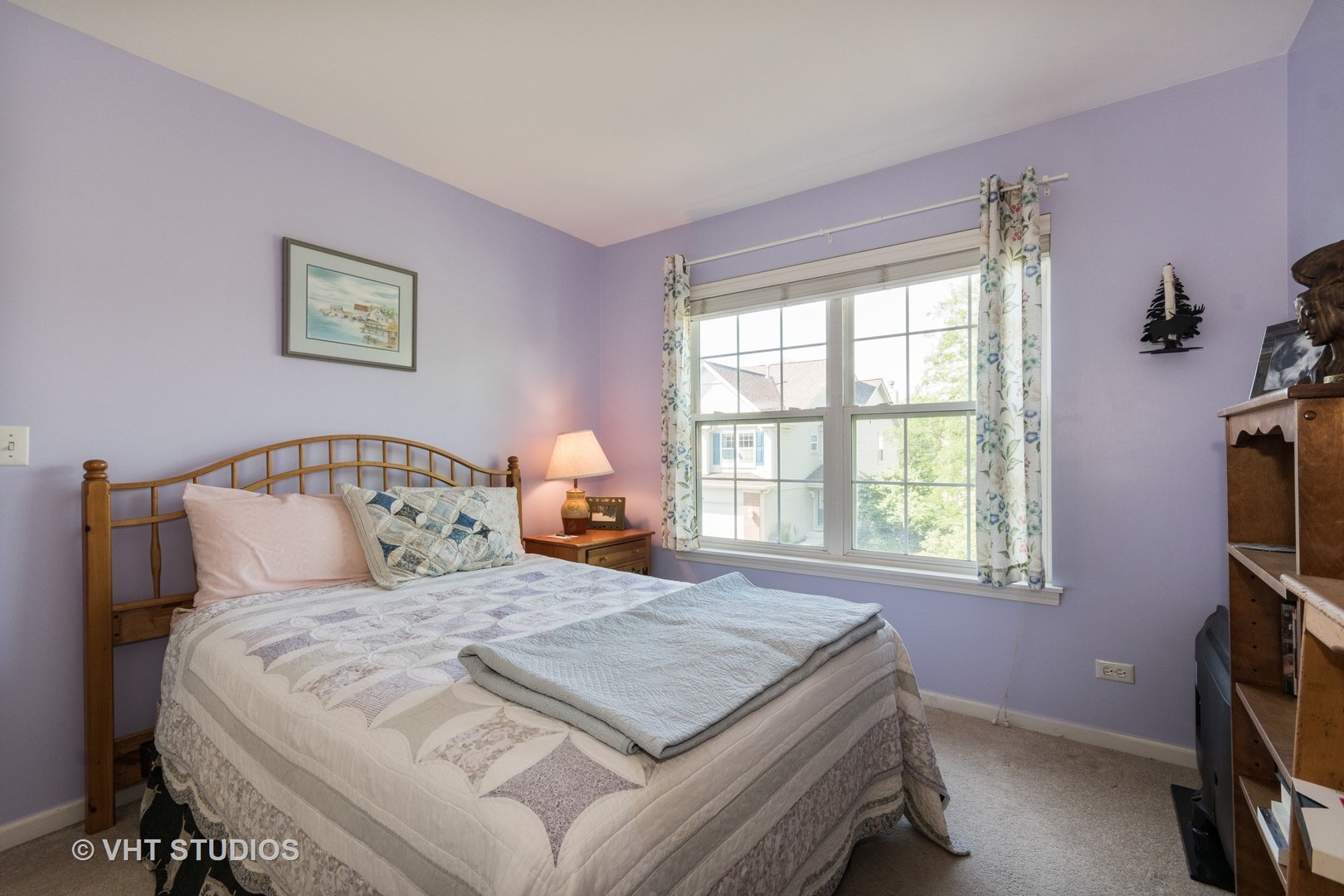 3132 Raphael Court St. Charles, IL 60175 - Photo 10 of 14 a bedroom with a bed and a flat tv screen on the dresser