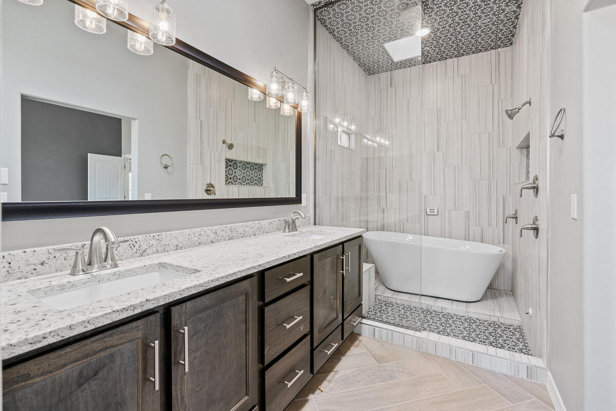 6026 Spring Ridge Sunland Park, NM 88008 - Photo 13 of 17 a bathroom with a granite countertop tub sink and mirror