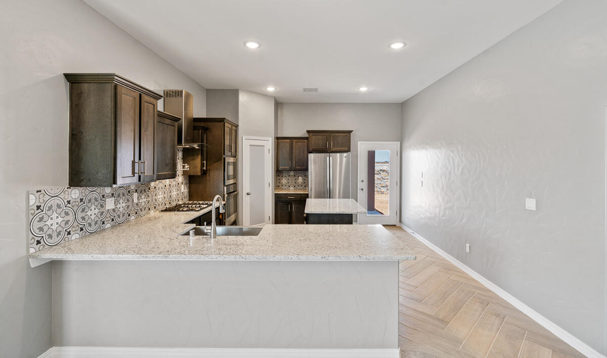 6026 Spring Ridge Sunland Park, NM 88008 - Photo 2 of 17 a view of a kitchen with a sink and mirror