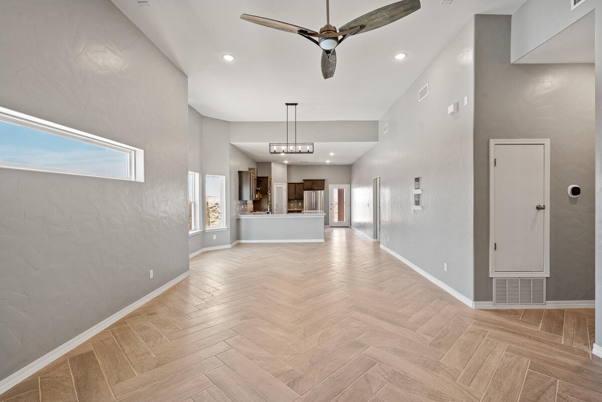 6026 Spring Ridge Sunland Park, NM 88008 - Photo 5 of 17 a view of a livingroom with a chandelier fan and kitchen view
