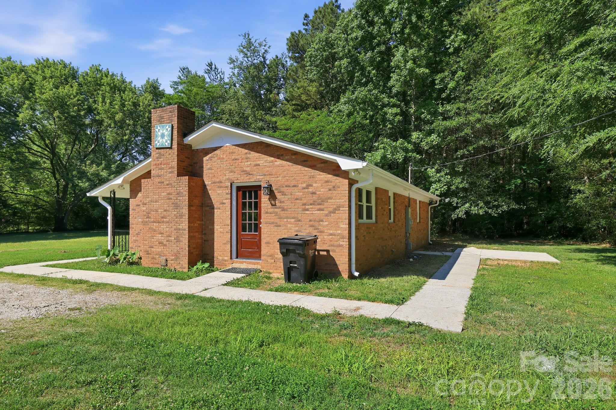 1108 Willoughby Road Monroe, NC 28110 - Photo 23 of 48 a view of a house with backyard and a tree