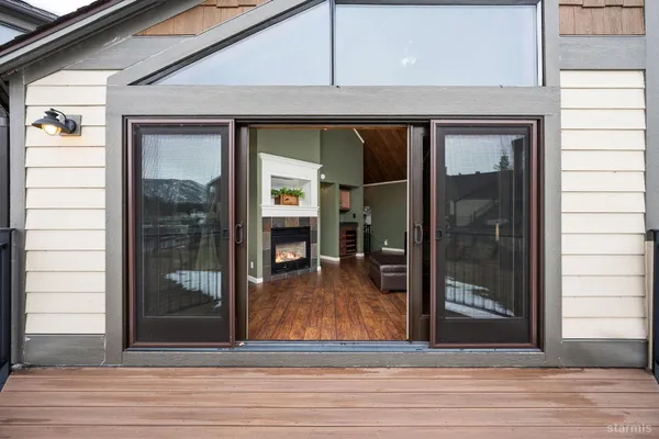 a view of a rooftop with chairs and a table