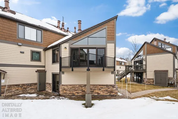 a view of a patio with a table and chairs