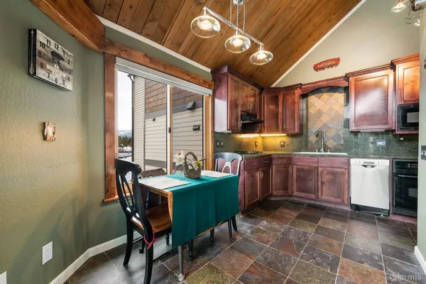 a kitchen with a table and chairs