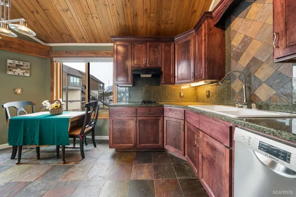 a kitchen with a sink cabinets and window