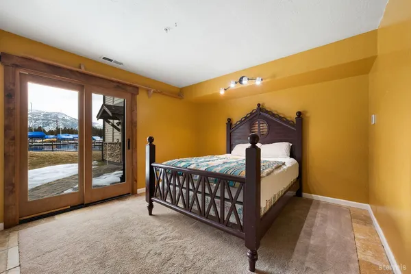 a bed sitting in a room next to a large window