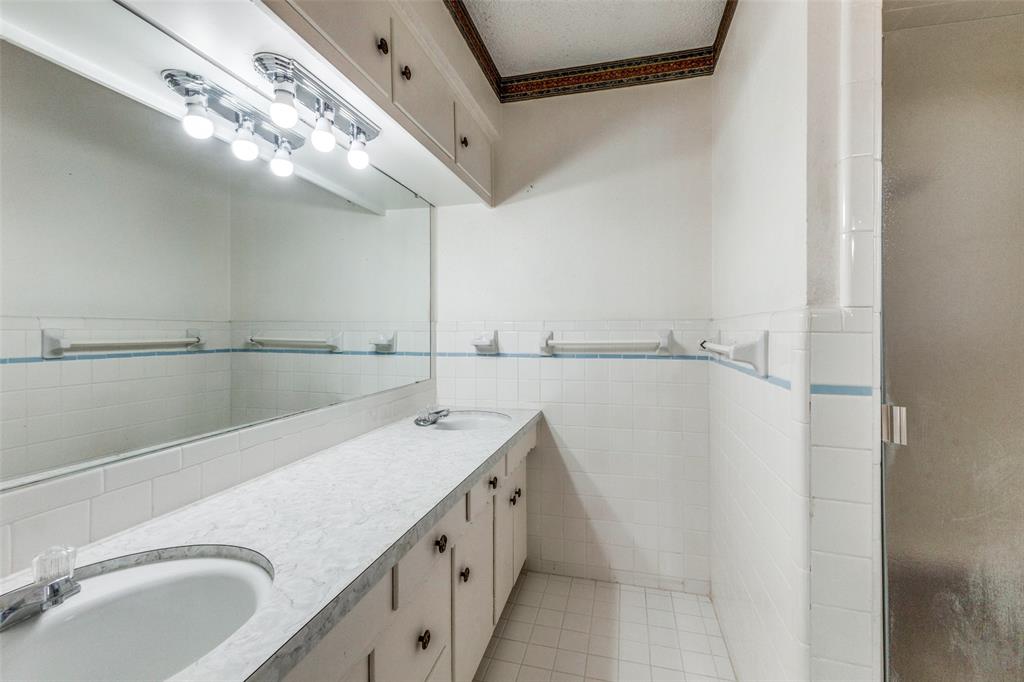 2271 Homeway Circle Dallas, TX 75228 - Photo 11 of 17 a bathroom with a double vanity sink and mirror