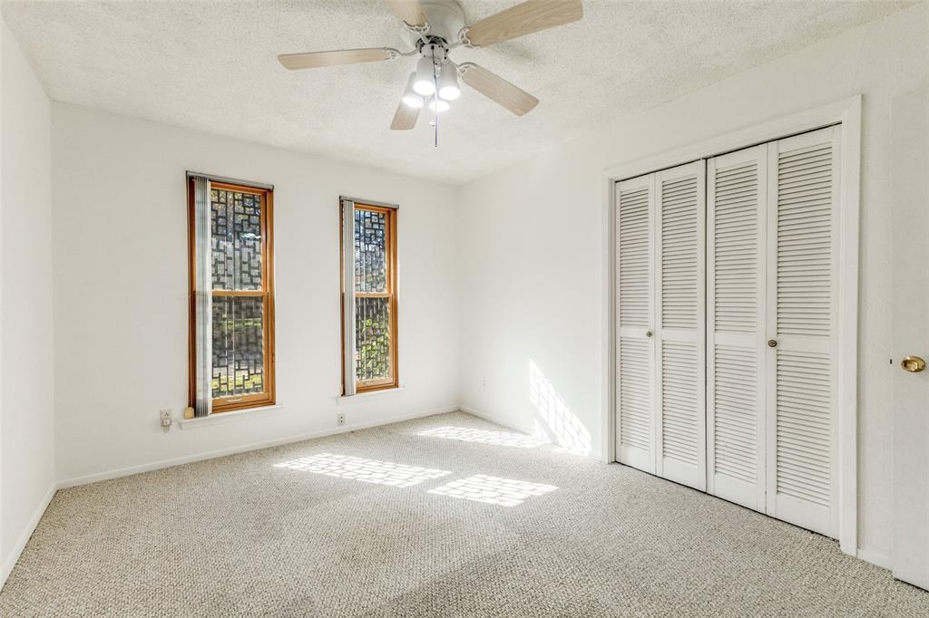 2271 Homeway Circle Dallas, TX 75228 - Photo 12 of 17 an empty room with windows and fan