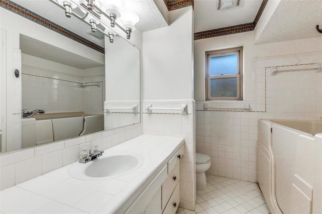 2271 Homeway Circle Dallas, TX 75228 - Photo 14 of 17 a bathroom with a sink toilet and shower