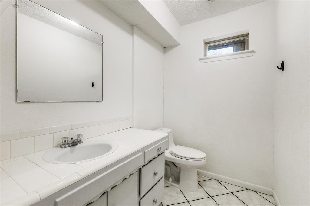 2271 Homeway Circle Dallas, TX 75228 - Photo 15 of 17 a bathroom with a sink a toilet and a mirror