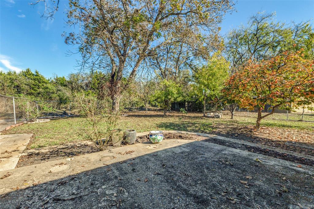 2271 Homeway Circle Dallas, TX 75228 - Photo 16 of 17 a view of a yard with wooden fence