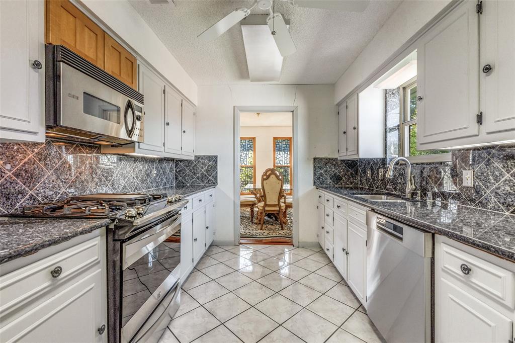 2271 Homeway Circle Dallas, TX 75228 - Photo 5 of 17 a kitchen with stainless steel appliances granite countertop a stove a sink and a microwave