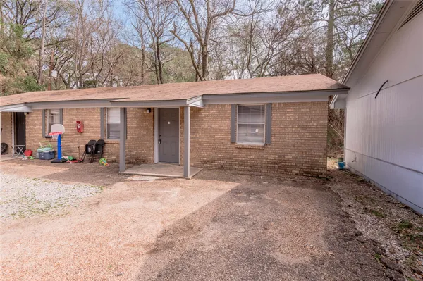 a view of a house with a yard and garage