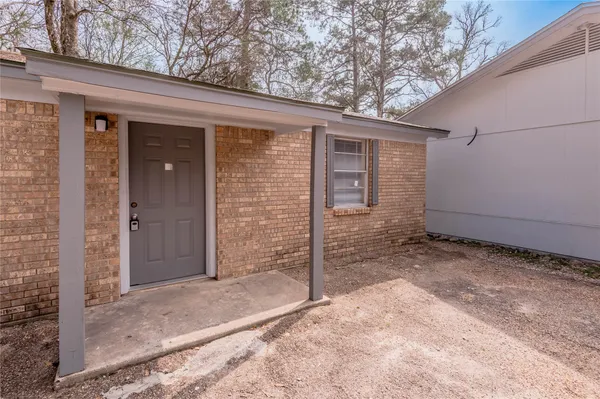 a view of a house with a small yard and garage