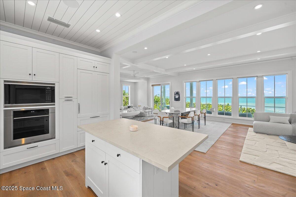 5525 Jimmy Buffett Mem Highway Melbourne Beach, FL 32951 - Photo 16 of 56 a view of kitchen with dining table and chairs