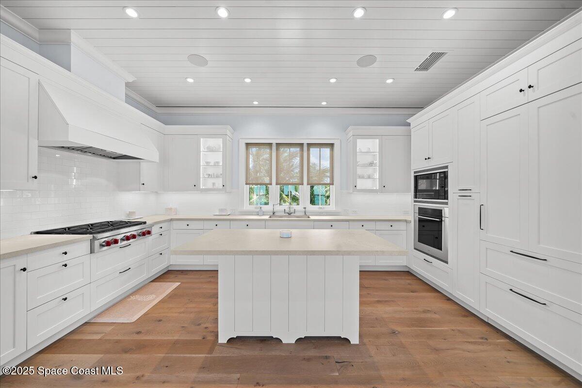 5525 Jimmy Buffett Mem Highway Melbourne Beach, FL 32951 - Photo 17 of 56 a large kitchen with stainless steel appliances granite countertop a stove and a sink