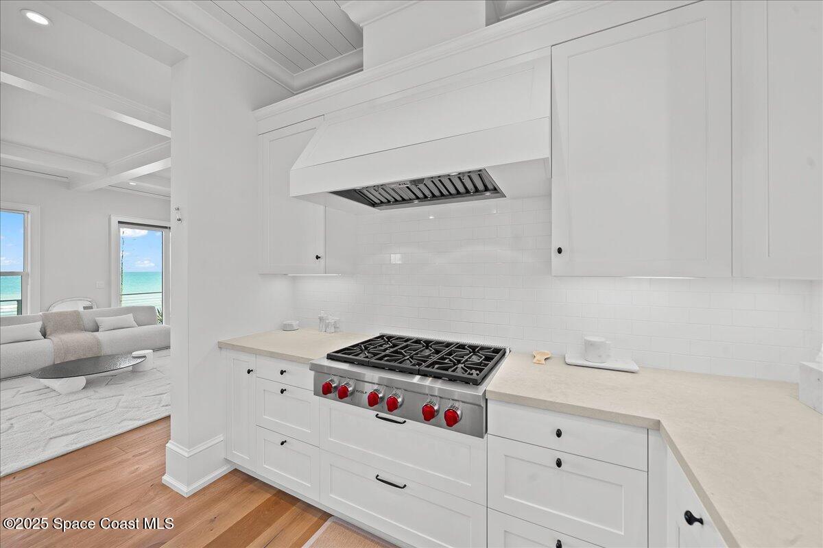 5525 Jimmy Buffett Mem Highway Melbourne Beach, FL 32951 - Photo 18 of 56 a kitchen with white cabinets and a stove