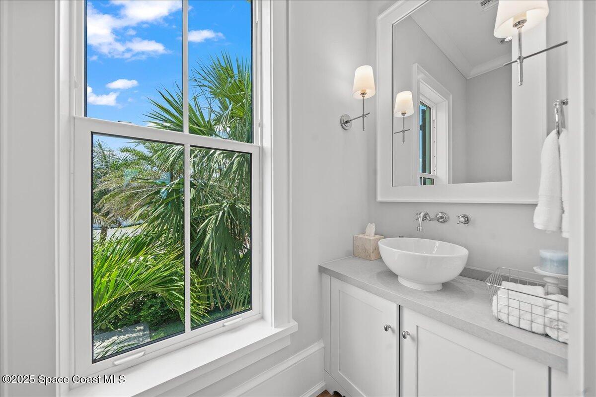 5525 Jimmy Buffett Mem Highway Melbourne Beach, FL 32951 - Photo 20 of 56 a bathroom with a sink and a mirror