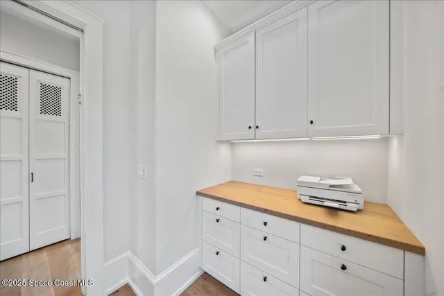 a living room with furniture and a book shelf