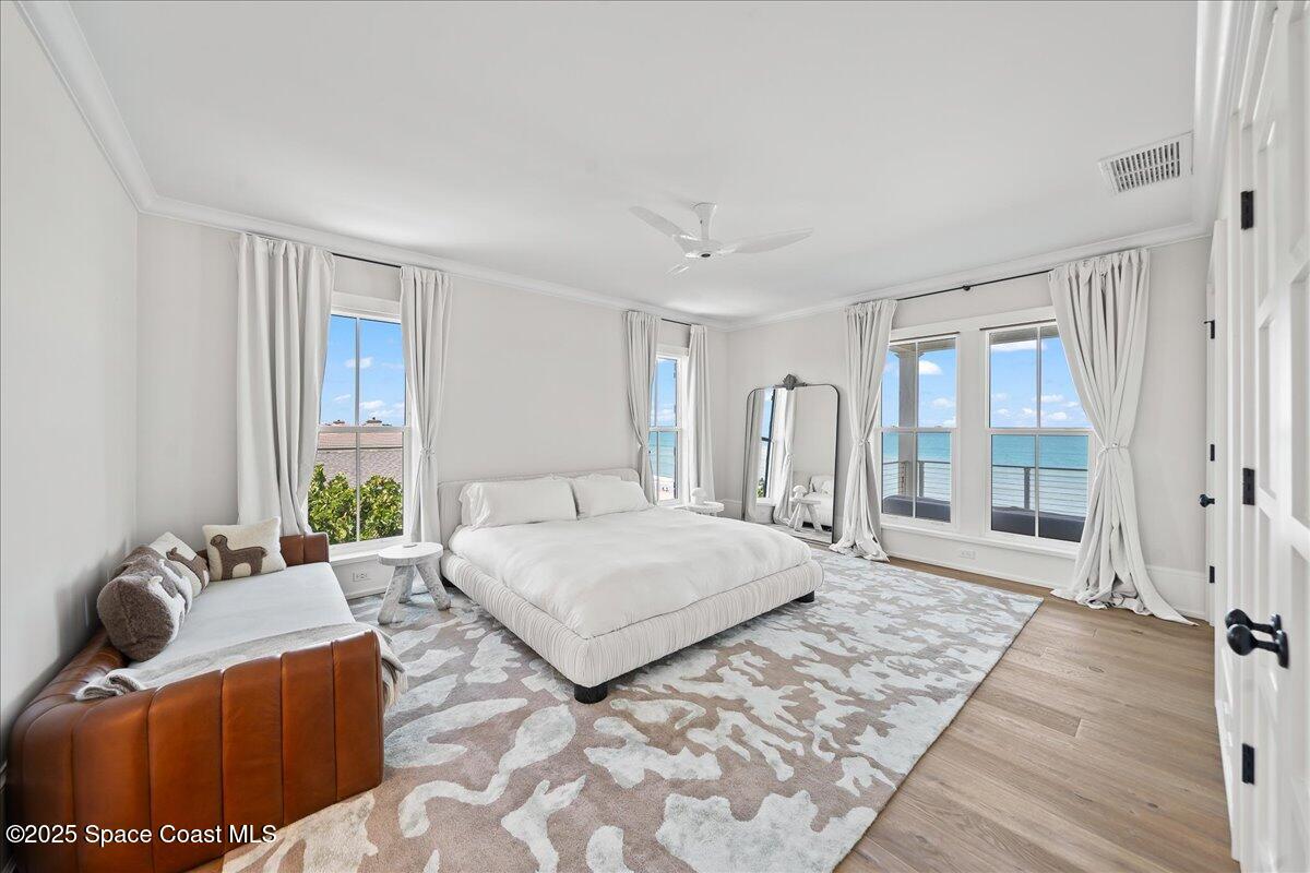 5525 Jimmy Buffett Mem Highway Melbourne Beach, FL 32951 - Photo 28 of 56 a spacious bedroom with a bed and glass window